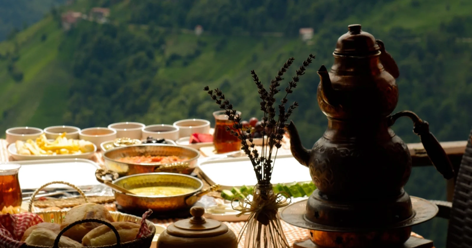 A breakfast table overlooking a green mountain valley